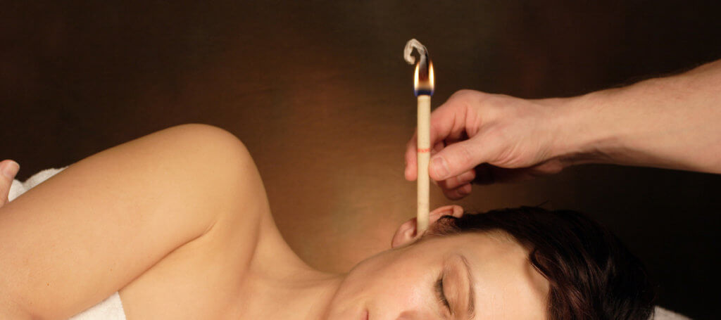 woman with ear candle therapy Ear Candle Therapy