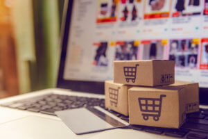 Shopping online concept - Shopping service on The online web. with payment by credit card and offers home delivery. parcel or Paper cartons with a shopping cart logo on a laptop keyboard Shopping online concept - Shopping service on The online web. with payment by credit card and offers home delivery. parcel or Paper cartons with a shopping cart logo on a laptop keyboard