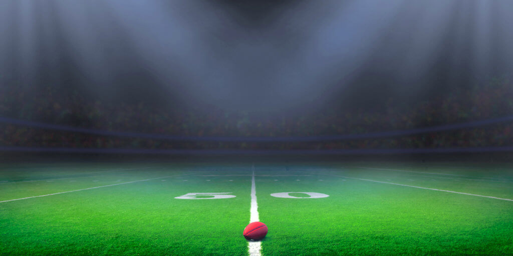 Football stadium American football field illuminated by stadium lights