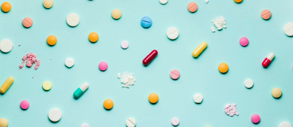 Pretty pills. crushed pills on blue background